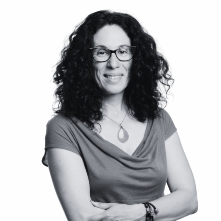 The image shows a black and white portrait of AllGenetics' staff Ania Pino-Querido.