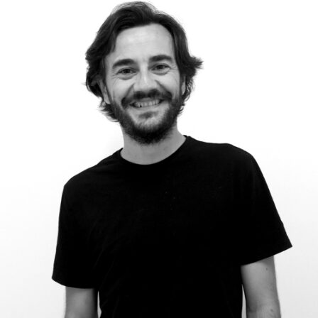 The image shows a black and white portrait of AllGenetics' staff Iago Fernández.
